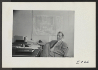 [recto] Paul A. Taylor, Project Director, seated casually at his desk. ;  Photographer: Parker, Tom ;  Denson, Arkansas.