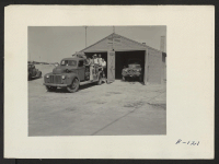 [recto] An efficient, well equipped fire department is an absolute necessity where 11,000 people are living in wood and tar paper barracks. Here one truck company of the Heart Mountain Fire Department sets off on a practice run. ;  Photographer: Parker, Tom