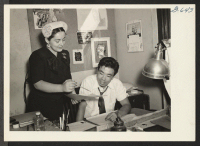[recto] Dorothy L. Scher (left), art director of a leading New York advertising agency, instructs commercial artist Ray Komai in a ...