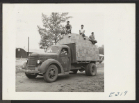 [recto] Voluntary workers transporting supplies from a railsiding to warehouses at this center by truck. ;  Photographer: Parker, Tom ;  McGehee, Arkansas.