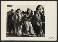 [recto] A cold December afternoon doesn't dampen the spirits of these primary school girls as they compete in a racing game with the primary boys. ;  Photographer: Parker, Tom ;  Amache, Colorado.