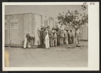 [recto] Workmen erecting barracks for evacuees of Japanese ancestry at assembly center on Pomona Fair Grounds. Evacuees will be assigned later to War Relocation Authority centers for the duration. ;  Photographer: Albers, Clem ;  Pomona, California.