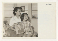 [recto] Mrs. George S. Takahashi and daughter, Kaye, age 5, of Topaz at home at 118 North Humboldt Street, San Mateo. ...
