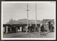 [recto] Crowd watches entrainment of segregees. ;  Newell, California.
