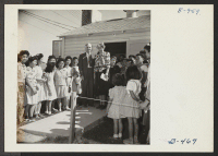[recto] Mrs. Eleanor Roosevelt, accompanied by Dillon Myer, National Director of the War Relocation Authority, visits the Gila Relocation Center, where they were greeted by crowds of enthusiastic evacuees. ;  Photographer: Stewart, Francis ;  Rivers, Arizona.