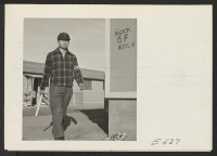 [recto] The center is guarded 24 hours a day by volunteer civilian police such as this patrolman, who is at the moment charged with the task of maintaining order and the dignity of law in block 6-F. ;  Photographer: Parker, Tom ;  Amache, Colorado.