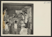 [recto] Closing of the Jerome Center, Denson, Arkansas. Typical scene in one of the box cars as transportation crews loaded personal belongings being shipped to other centers. ;  Photographer: Iwasaki, Hikaru ;  Denson, Arkansas.