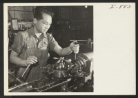 [recto] Frank Kubota, a returned veteran, at work in the machine shop of the Ravenna Metal Products company in Seattle. Kubota ...