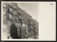 [recto] Mr. and Mrs. Misao Tajitsu, Issei from the Minidoka Relocation Center, are standing outside the New York City apartment house ...