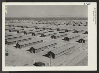 [recto] Living quarters of evacuees of Japanese ancestry at this War Relocation Authority center, as seen from the top water tower facing southwest. ;  Photographer: Clark, Fred ;  Poston, Arizona.