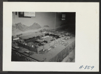 [recto] New Year's Fair. Model of proposed swimming pool. This model was built by evacuee craftsmen for display in the agricultural exhibit. ;  Photographer: Stewart, Francis ;  Poston, Arizona.