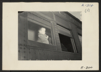 [recto] Lone Pine, Calif.--A young evacuee of Japanese ancestry arrives here by train prior to being transferred by bus to Manzanar, now a War Relocation Authority center. ;  Photographer: Albers, Clem ;  Lone Pine, California.