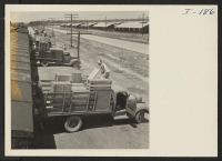 [recto] Closing of the Jerome Center, Denson, Arkansas. Loading freight cars with the personal possessions of Jerome residents being moved to the Gila River Center. ;  Photographer: Iwasaki, Hikaru ;  Denson, Arkansas.