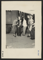 [recto] Lone Pine, Calif.--Evacuees of Japanese ancestry arrive here by train and await buses for Manzanar, now a War Relocation Authority center. ;  Photographer: Albers, Clem ;  Lone Pine, California.