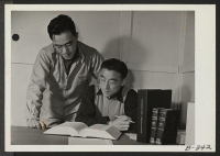 [recto] (L. to R.) Victor Abe, and Shozo Tsuchida, former law students from San Francisco, California, are members of the legal staff in the Project Attorney's office, at this War Relocation Authority Center. ;  Photographer: Stewart, Francis ;  Topaz, Utah.
