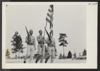 [recto] The regimental color guard passes in review. The 442nd combat team at Camp Shelby is composed entirely of Americans of ...