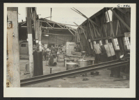 [recto] Interior of motor pool garage at Granada Center, showing effects of tornado-like storm which struck camp on the evening of June 25, 1945. ;  Photographer: McGovern, Melvin P. ;  Amache, Colorado.