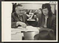 [recto] A scene in the Chicago Relocation Division of the War Relocation Authority where relocatees are being interviewed for relocation and assistance. ;  Photographer: Iwasaki, Hikaru ;  Chicago, Illinois.