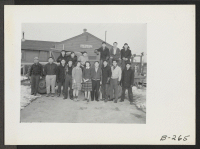 [recto] The staff of firemen at Fire Station No. 1. The two girls in the center, are the Mascots of the group, and are the stenographers who work in their office. ;  Photographer: Stewart, Francis ;  Newell, California.