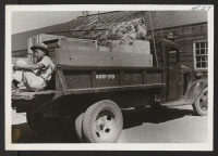 [recto] Truck load of personal effects arrive at rail head for shipment to Jerome. ;  Newell, California.