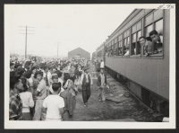 [recto] OUTGOING--Crowd at track just before train left. ;  Photographer: Aoyama, Bud ;  Heart Mountain, Wyoming.