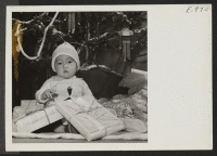 [recto] Nine month old Takashi Yoshida symbolizes the spirit of Christmas at the Granada Relocation Center, where persons of Japanese ancestry ...