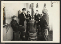 [recto] A large iron stove is enjoyed on cold winter days by the evacuee workers in the motor pool. ;  Photographer: Parker, Tom ;  Newell, California.