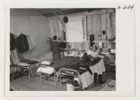 [recto] Evacuees of Japanese descent enjoy a moment of relaxation before setting up housekeeping at this assembly center. They will be transferred ultimately to a War Relocation Authority Center. ;  Photographer: Albers, Clem ;  Salinas, California.