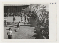 [recto] New Year's Fair. A basketball game was held as part of the athletic events to commemorate the New Year. ;  Photographer: Stewart, Francis ;  Poston, Arizona.