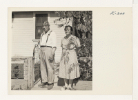 [recto] Taken in front of the home of Mr. and Mrs. K. Sasaki. Picture of Mr. and Mrs. Sasaki, whose son, T/4 Tom, is now in Okinawa as an interpreter in the United States Army Intelligence Service. These folks were formerly of Granada. ;  Photographer: Iwasaki,