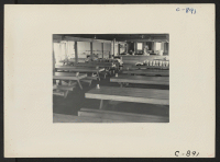 [recto] Manzanar, Calif.--Mess Hall No. 16 at this War Relocation Authority center for evacuees of Japanese ancestry. An average of 290 persons are fed three meals a day in each mess hall, and all work is done by the evacuees themselves. ;  Photographer: Lange,