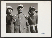 [recto] Farm workers who participated in the Harvest Festival Parade held at this relocation center. Their hats were fashioned from turnips. ;  Photographer: Stewart, Francis ;  Newell, California.