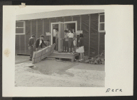 [recto] The exterior of the medical and optometry field clinic at this center. ;  Photographer: Parker, Tom ;  Denson, Arkansas.