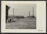 [recto] One of the hospital wings showing the heating plant area. One wing is in use and the other is under construction. ;  Photographer: Parker, Tom ;  Denson, Arkansas.
