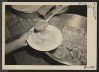 [recto] Manzanar, Calif.--Meals are being served cafeteria style at this War Relocation Authority center. ;  Photographer: Albers, Clem ;  Manzanar, California.