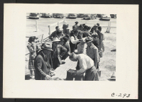 [recto] Turlock, Calif.--Baggage is inspected as families arrive at Turlock Assembly center. Evacuees of Japanese ancestry will be transferred later to War Relocation Authority centers where they will spend the duration. ;  Photographer: Lange, Dorothea ;  Tu