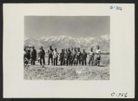 [recto] Manzanar, Calif.--Farm crew of which Johnny Fukazawa is foreman. These men are ready to return to the center's mess hall for lunch after a busy morning in the fields of the farm project at this War Relocation Authority Center. ;  Photographer: Lange, Do