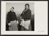 [recto] Two women of Japanese ancestry pause from their potato harvesting to pose for this picture. ;  Photographer: Stewart, Francis ;  Newell, California.