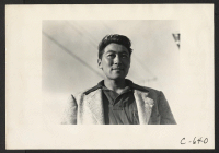 [recto] Tanforan Assembly Center, San Bruno, Calif.--Portrait of youth of Japanese ancestry from a farming district in central California. ;  Photographer: Lange, Dorothea ;  San Bruno, California.
