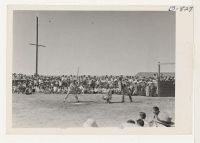 [recto] A tense moment in the Amache-Prowers County all-star baseball game held in the center Sunday, September 12, 1943, in connection with the Amache Agricultural Fair. Amache won 20-9. ;  Photographer: McClelland, Joe ;  Amache, Colorado.