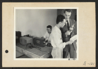 [recto] Poston, Ariz.--Kay Nishimura, evacuee of Japanese ancestry, and Chet Huntley (right), CBS announcer, in an interview at this War Relocation Authority center during a nationwide hookup. ;  Photographer: Clark, Fred ;  Poston, Arizona.